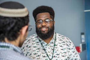Young black man speaking to Jewish male